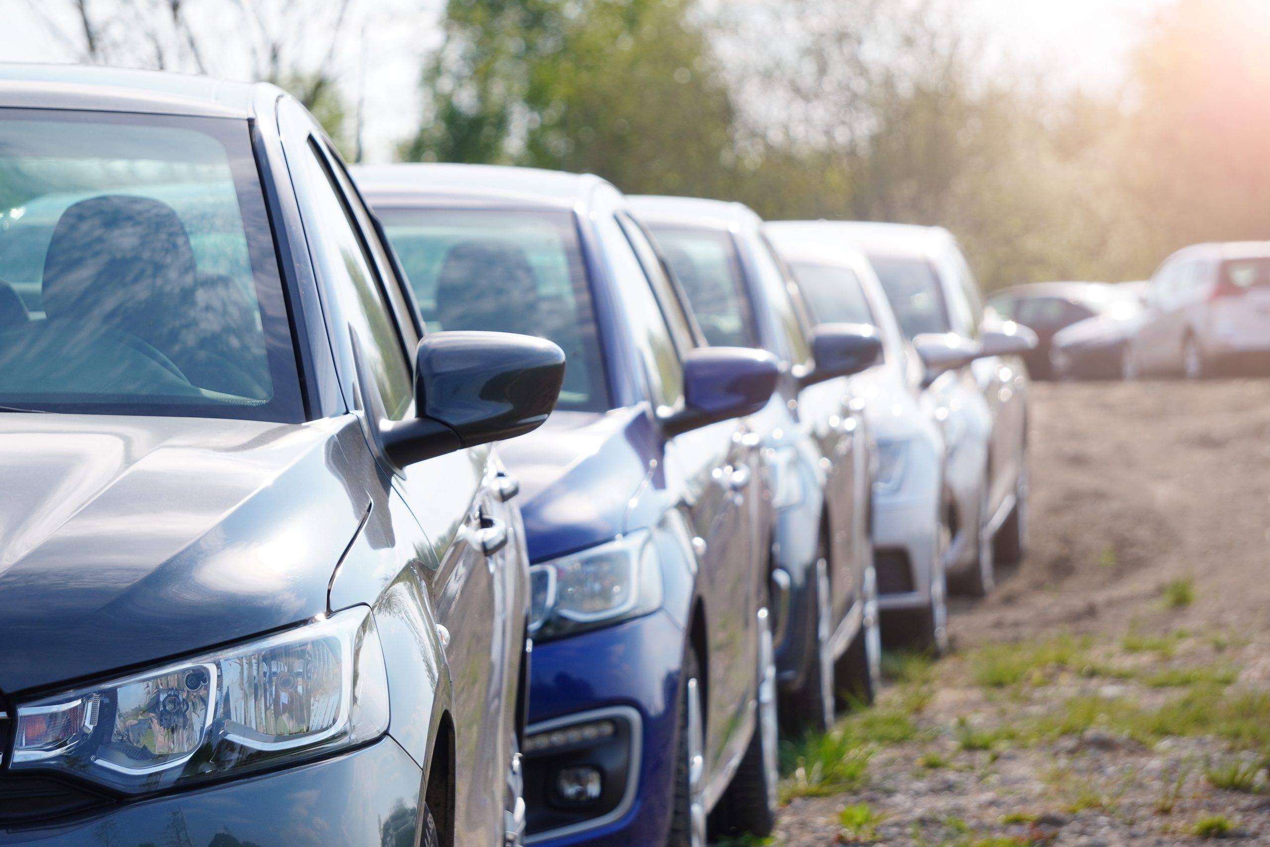 Identical Blue Cars Stand In A Row In A Parking Lot Or Market For Sale. View Of The Side Mirrors, The Dealership. New Car Sales. Receiving A Car On Commission. Global Auto Industry Crisis Identical Blue Cars Stand In A Row In A Parking Lot Or Market For Sale. View Of The Side Mirrors, The Dealership. New Car Sales. Receiving A Car On Commission. Global Auto Industry Crisis