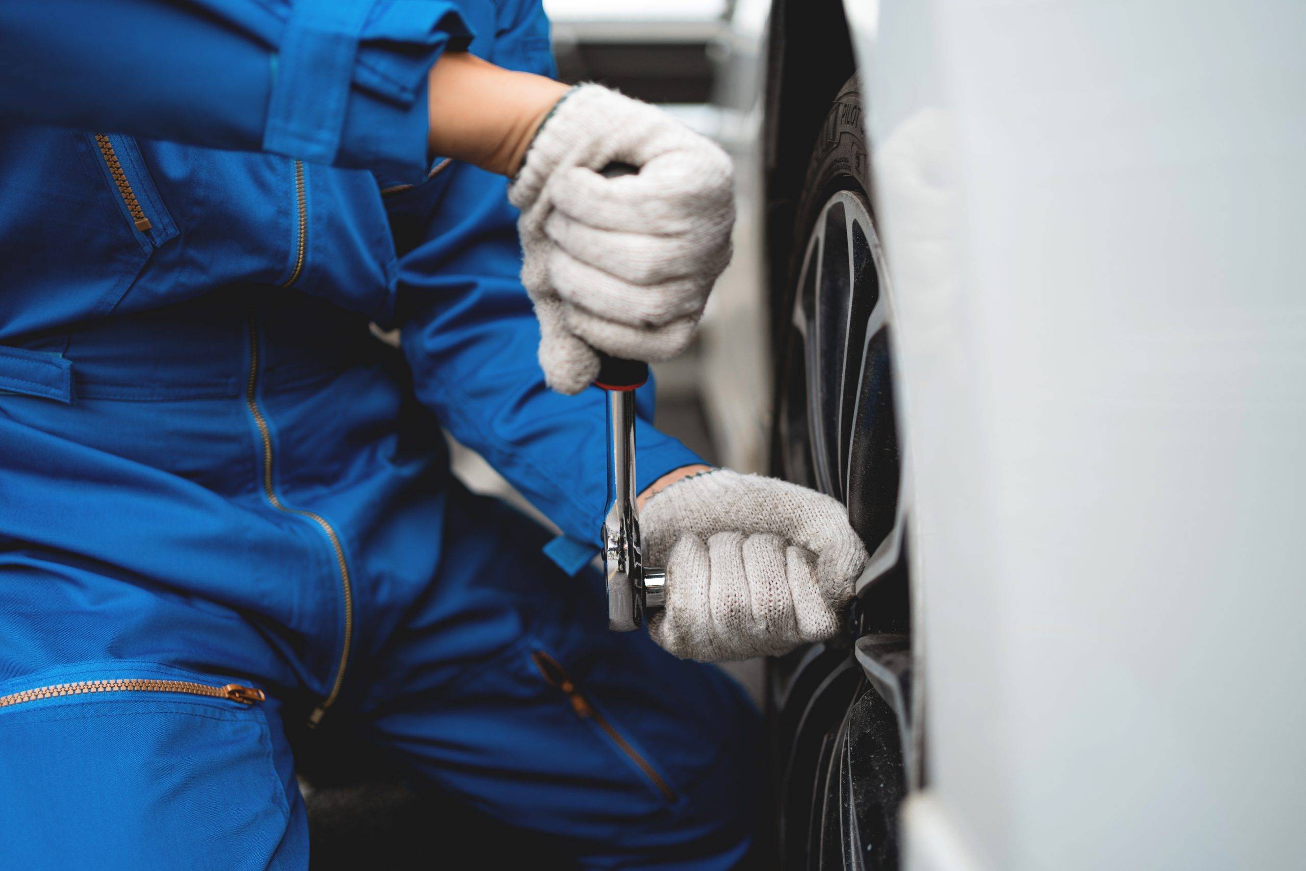 A Mechanic Is Working On A Car Tire. Concept Of Focus And Determination As The Mechanic Works To Fix The Tire A Mechanic Is Working On A Car Tire. Concept Of Focus And Determination As The Mechanic Works To Fix The Tire